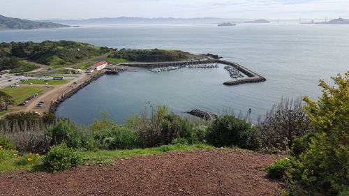 Scenic view of harbour with mountain range in background