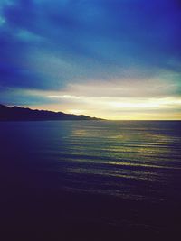 Scenic view of sea against cloudy sky