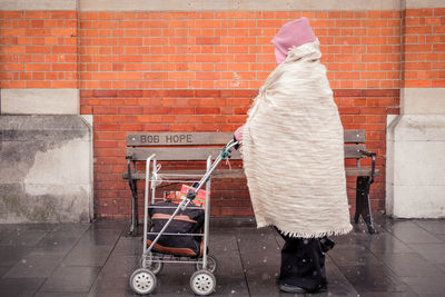 Rear view of man standing on footpath