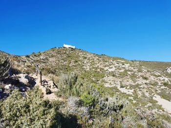 Scenic view of mountains against clear blue sky