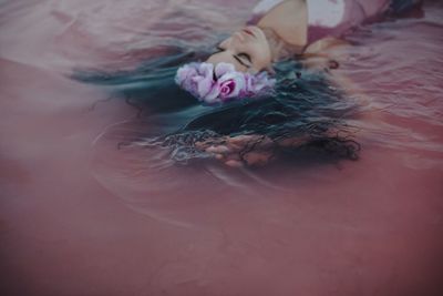 High angle view of woman lying down on bed