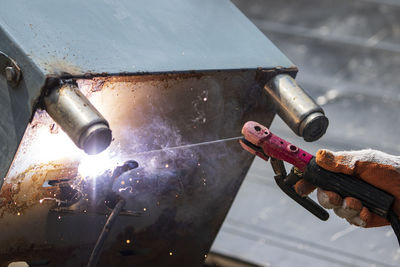 High angle view of person working on metal