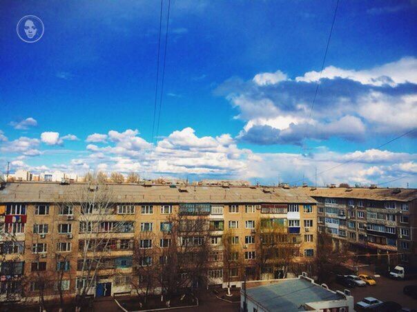 building exterior, architecture, built structure, sky, car, transportation, city, street, blue, land vehicle, mode of transport, residential building, road, building, residential structure, cloud, city life, cloud - sky, street light, outdoors