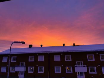 Low angle view of building against sky at sunset