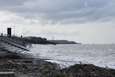 Scenic view of beach against sky during winter