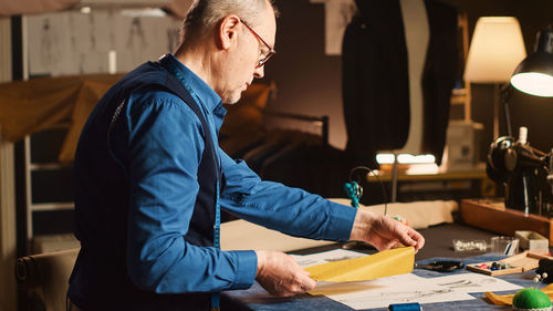 Side view of man working at office