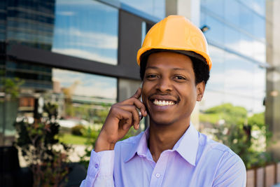 Portrait of smiling young man using mobile phone