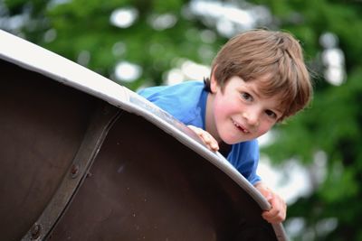 Portrait of boy smiling on a slide