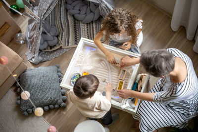 High angle view of mother and daughter at home