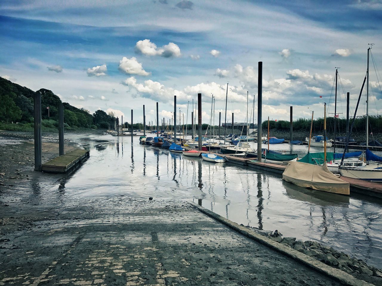 BOATS MOORED AT HARBOR