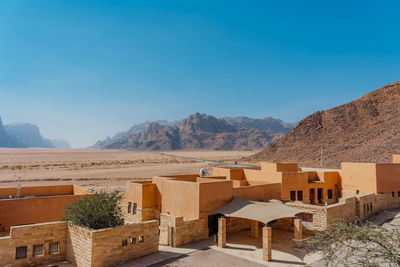 Scenic view of desert against clear blue sky