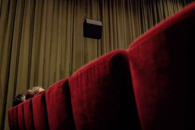 Low angle view of red seats in theatre