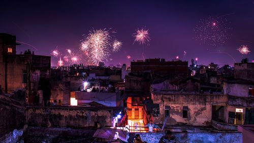 Firework display against sky at night