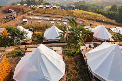 High angle view of tent on field against buildings