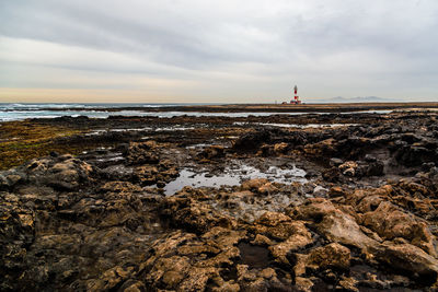 Scenic view of sea with rocky beach against sky. fuerteventura, canary islands, spain