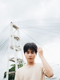 Young woman against sky