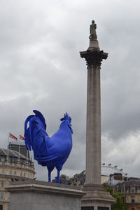 Low angle view of statue against cloudy sky