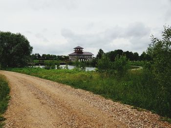 Road by building against sky