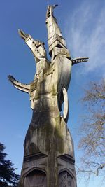 Low angle view of statue against blue sky