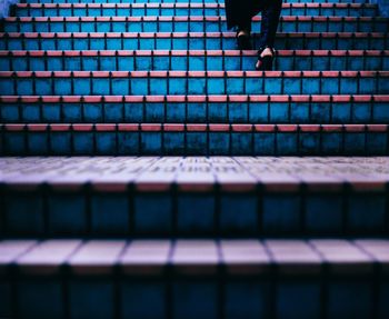 Low section of man standing on tiled floor