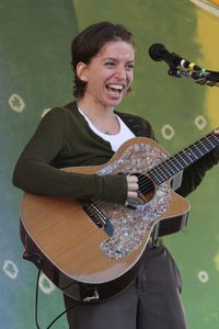 Portrait of a smiling young man playing guitar