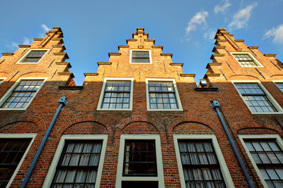 Haarlem, netherlands. row of three houses with stepped gables. low angle view.