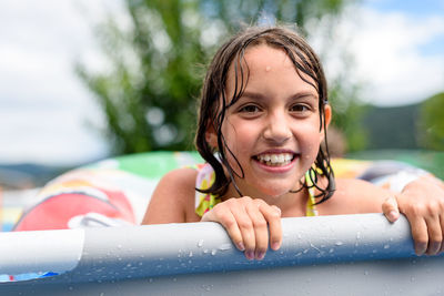 Portrait of young woman swimming in park