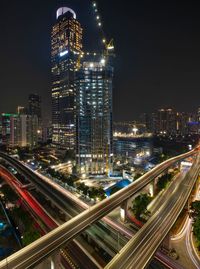 Aerial view of illuminated buildings in city at night