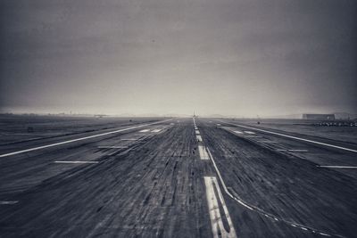 Airplane on road against sky