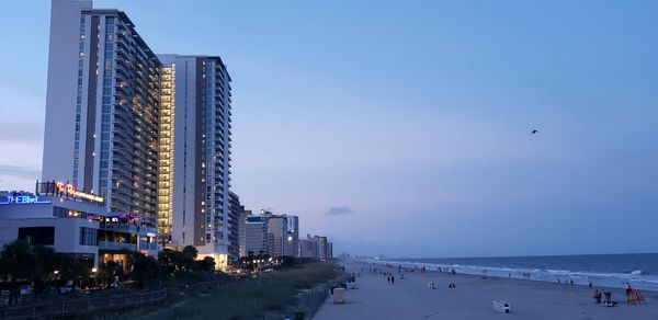 Panoramic view of beach against sky at dusk