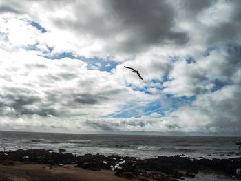 Scenic view of sea against cloudy sky