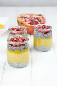 Close-up of fresh smoothie with chia seeds in jars on table