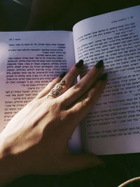 Midsection of woman reading book