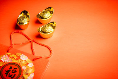 Close-up of coins against orange background