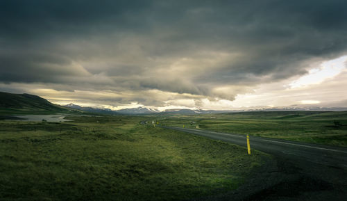 Scenic view of landscape against dramatic sky