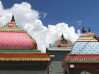 Low angle view of pagoda against cloudy sky