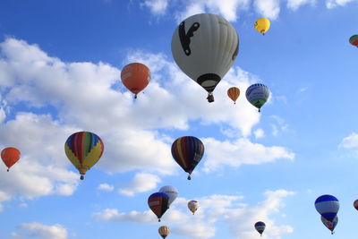 Low angle view of balloons flying against sky