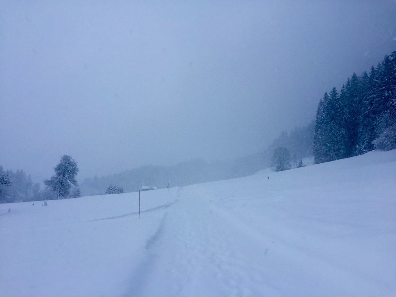 SNOW COVERED LAND AGAINST SKY