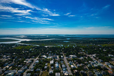 Aerial view of buildings in town against sky