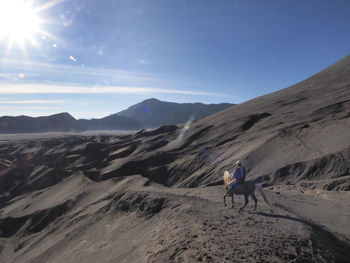 Man riding horse in desert