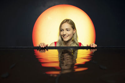 Portrait of young woman in swimming pool