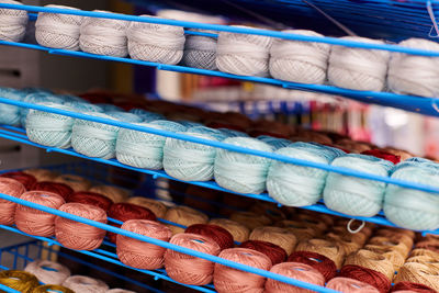 Yarns or balls of wool on shelves in store for knitting and needlework. accessories for haberdashery