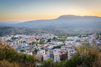 High angle view of city against sky during sunset