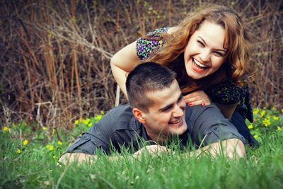 Cheerful couple lying on grassy land