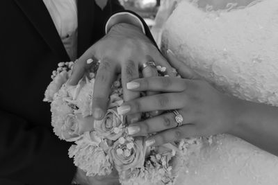Midsection of woman holding flower bouquet