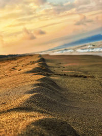 Scenic view of desert against sky during sunset