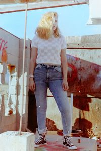 Portrait of young woman standing on floor