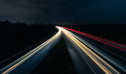 High angle view of light trails on highway at night