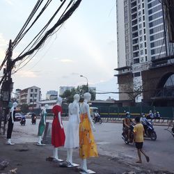 People walking on street against buildings in city