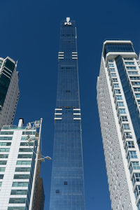 Low angle view of buildings against blue sky